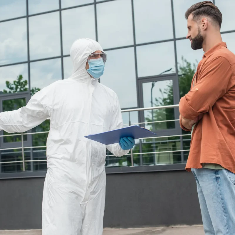 medical-worker-in-hazmat-suit-holding-clipboard-an-2024-11-09-07-15-06-utc